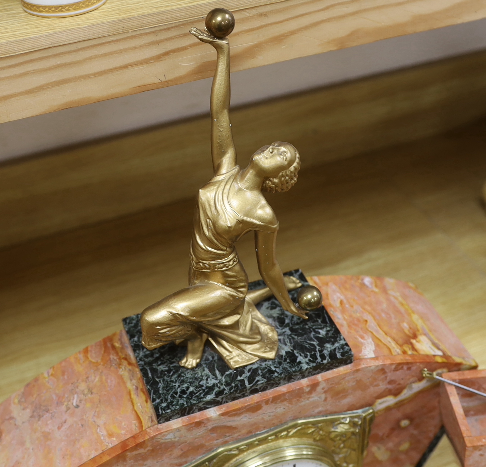 An early 20th century French rouge marble and gilt metal clock garniture, with key and pendulum, 49cm